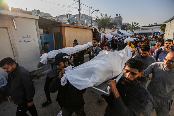 People mourn as they collect the bodies of Palestinians killed in an airstrike on December 02, 2023 in Khan Yunis, Gaza.