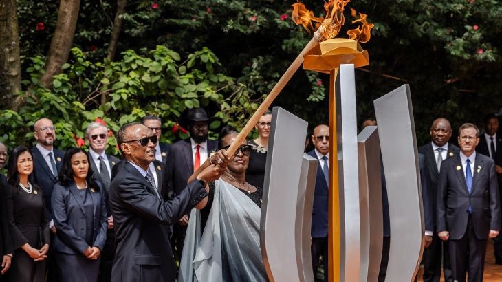 TOPSHOT - President of Rwanda Paul Kagame (C L) and his wife Jeannette Kagame (C R) light a remembrance flame surrounded by heads of state and other dignitaries as part of the commemorations of the 30th Anniversary of the 1994 Rwandan genocide at the Kigali Genocide Memorial in Kigali on April 7, 2024. Rwanda on Sunday paid solemn tribute to genocide victims, 30 years after a vicious campaign orchestrated by Hutu extremists tore apart the country, as neighbours turned on each other in one of the bloodiest massacres of the 20th century. The killing spree, which lasted 100 days before the Rwandan Patriotic Front (RPF) rebel militia took Kigali in July 1994, claimed the lives of around 800,000 people, largely Tutsis but also moderate Hutus. (Photo by LUIS TATO / AFP) RELATED CONTENT