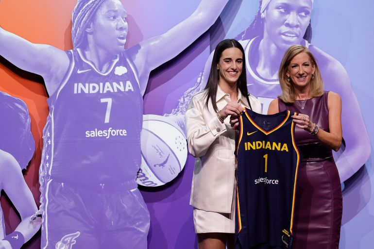 Caitlin Clark receives her Indiana Fever jersey.